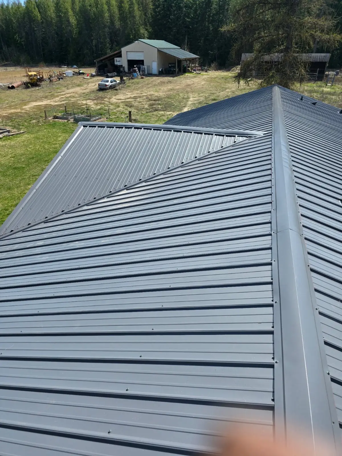Dark grey standing seam metal roof on a rural Spokane-area property